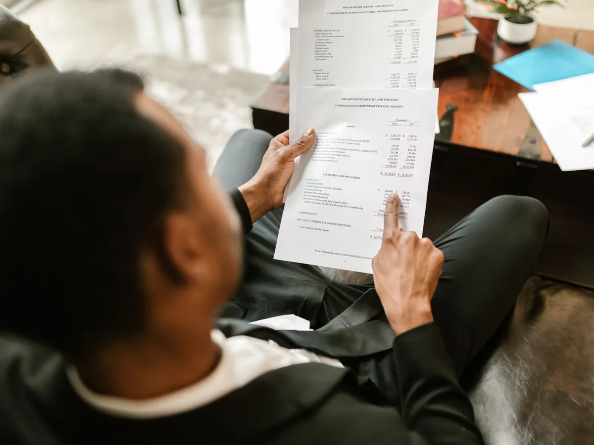 Professionnel examinant des documents financiers et des analyses dans un bureau