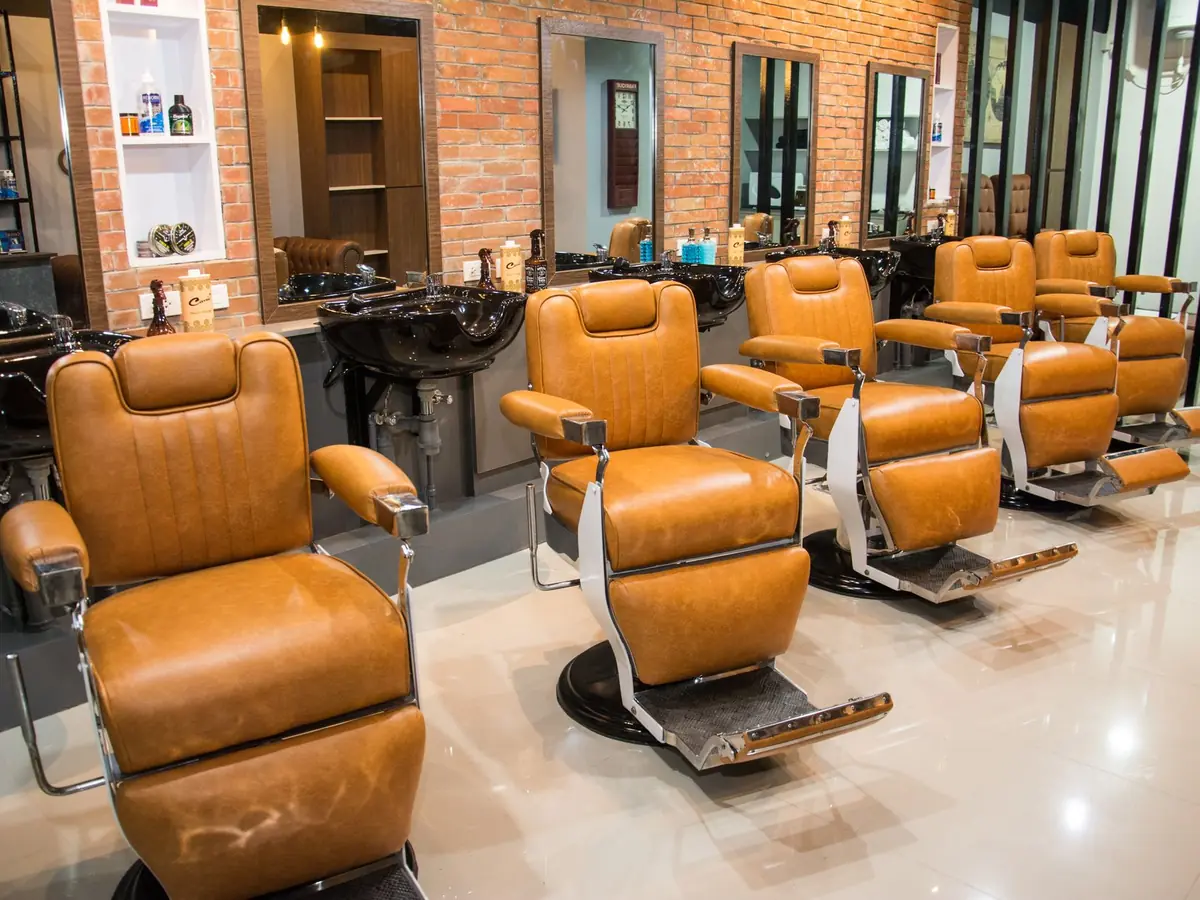 Salon de coiffure avec ses fauteuils alignés devant les miroirs